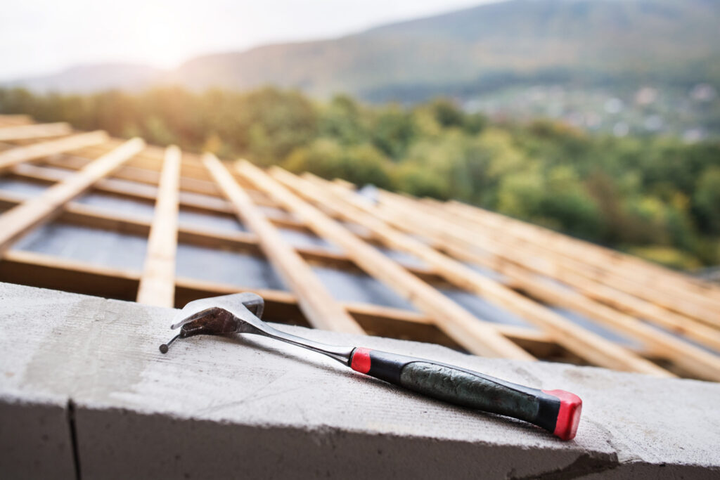 Hammer on the roof on the construction site - J&K Roofing