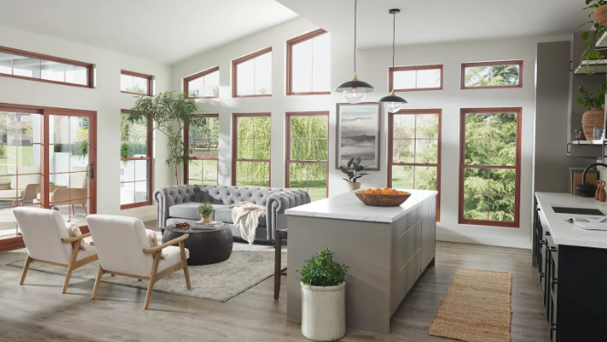 Bright and airy modern living space illuminated by energy-efficient windows with thermal insulation, providing a clear view of the natural surroundings while maintaining indoor temperature and reducing energy costs.