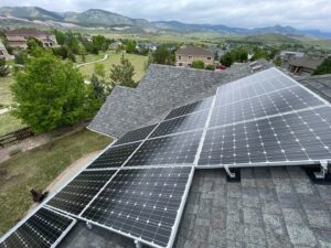 Eco-friendly roofing solution with solar panels installed on a residential roof, overlooking a scenic view of rolling hills and a suburban neighborhood, promoting sustainable energy in home design.