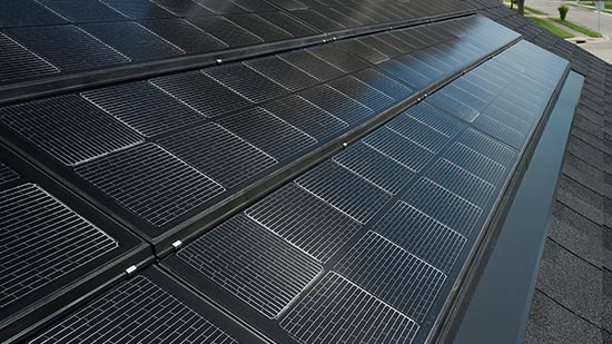 Close-up of black solar panels on a residential roof.