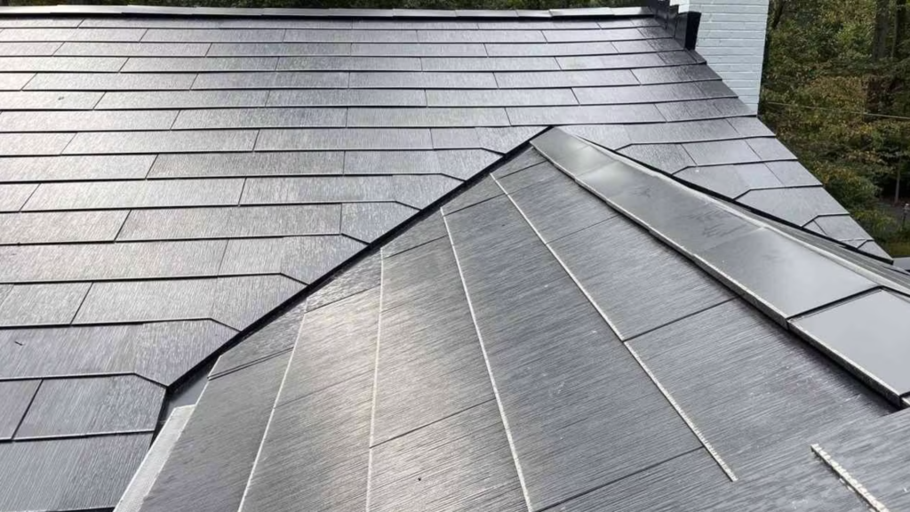Solar panels integrated into a gray shingled rooftop.