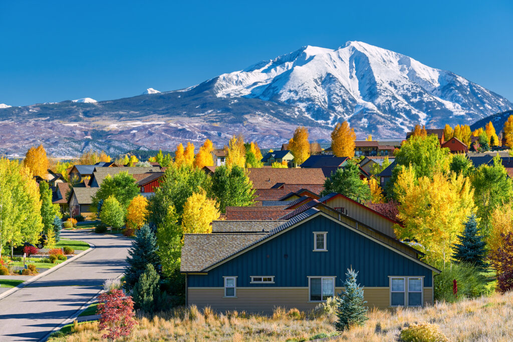 Residential neighborhood in Colorado at autumn. Homes have various types of the best siding for homes in colorado to protect them from the elements