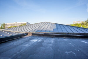 commercial roof hail damage on a black commercial roof after a hail storm in Denver Colorado