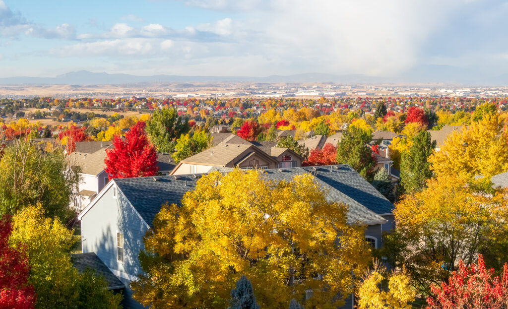 Colorado Living. Centennial, Colorado - Denver Metro Area Residential Autumn Panorama with the view of a Front Range mountains in the distance during the fall