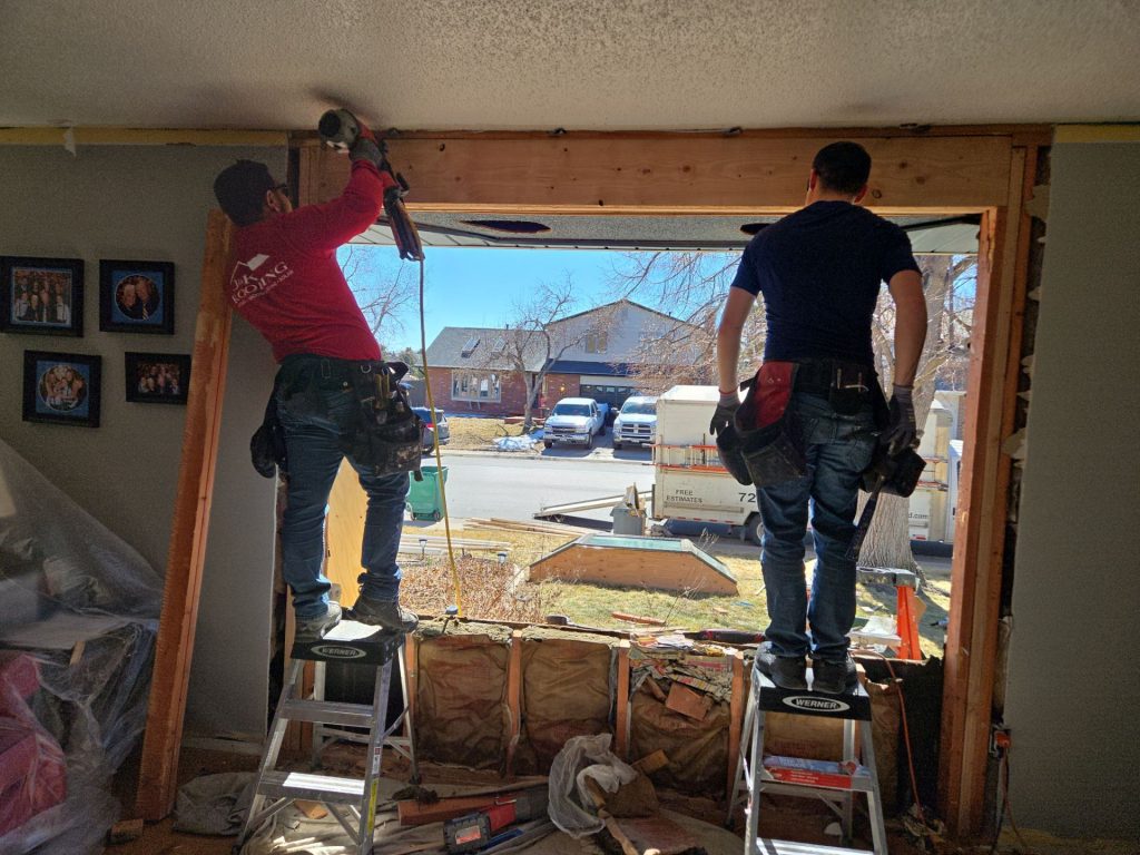 contractors installing new windows to create a more energy efficient home