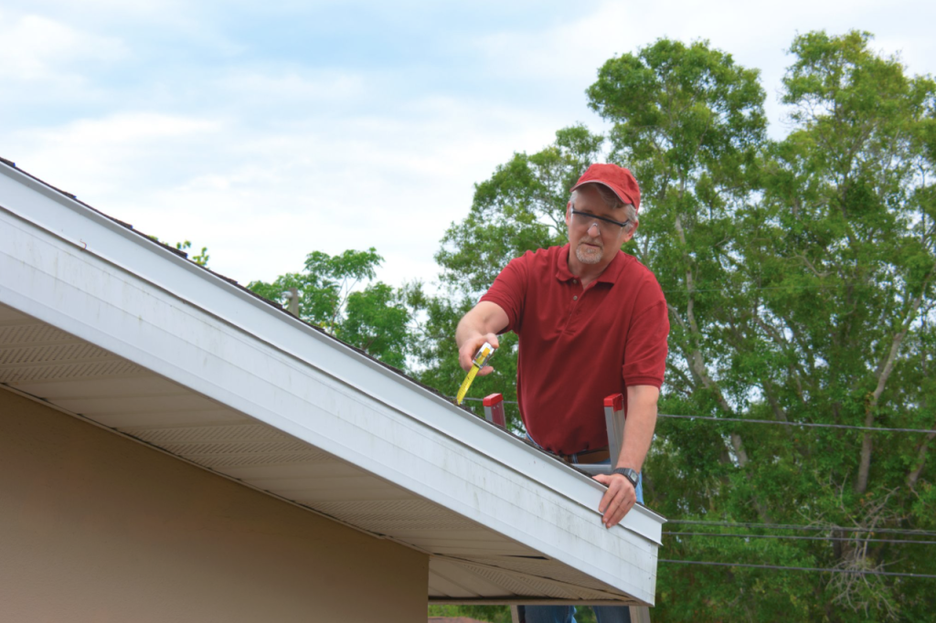 man making roof inspection showing how long does a roof inspection take